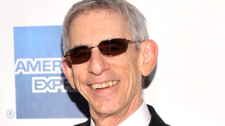 Richard Belzer smiling with sunglasses on