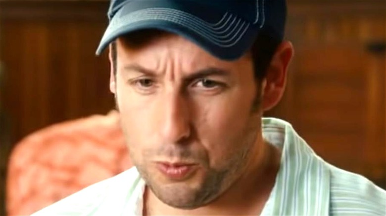 Adam Sandler wearing blue baseball cap