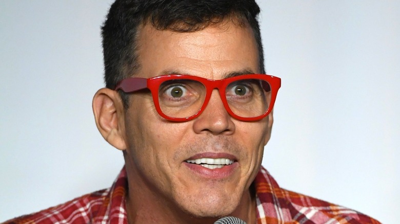 Steve-O wearing red glasses