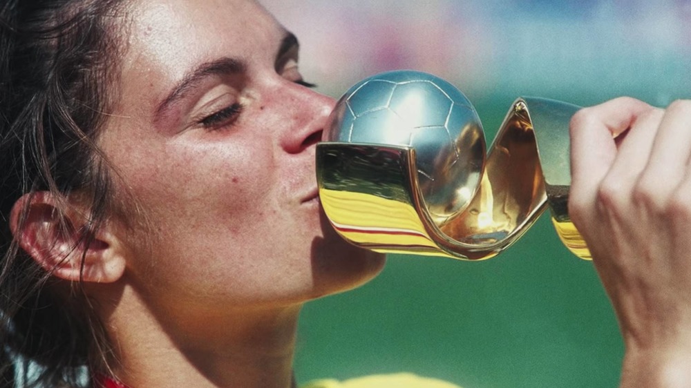 Soccer player kissing trophy