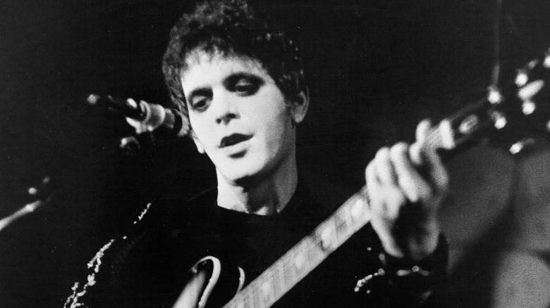 Lou Reed playing guitar and singing