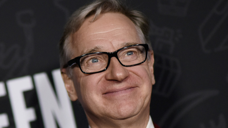 Paul Feig smiling red suit