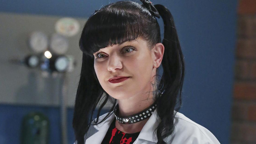 Abby smiling and looking at something off camera on NCIS