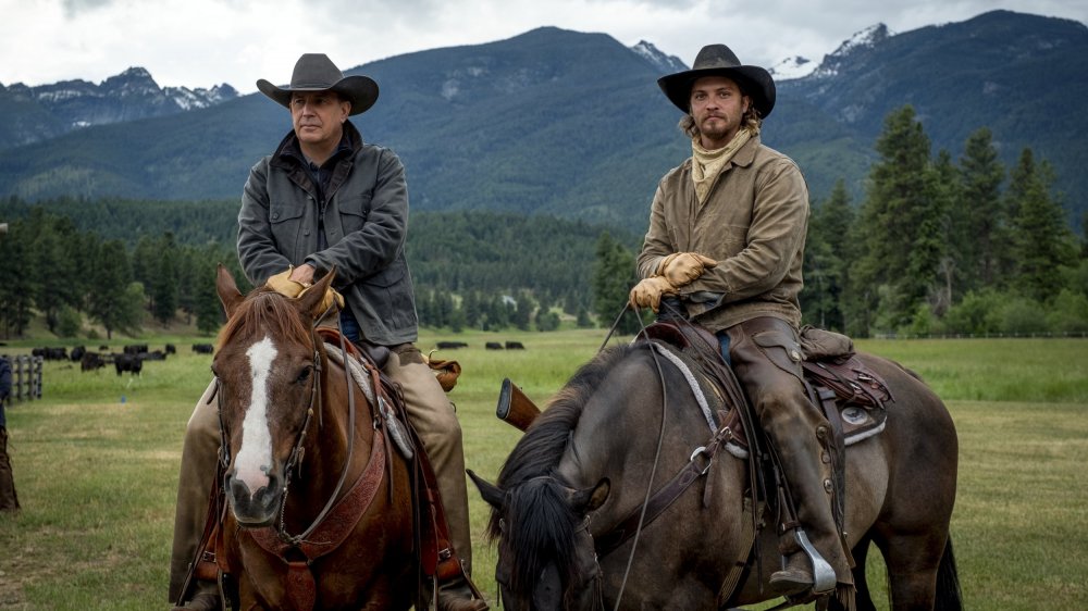 John Dutton (Kevin Costner) and Kayce Dutton (Luke Grimes) ride horses on Yellowstone