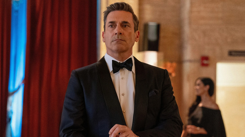 Coop in a suit fixing his cuffs on Your Friends and Neighbors