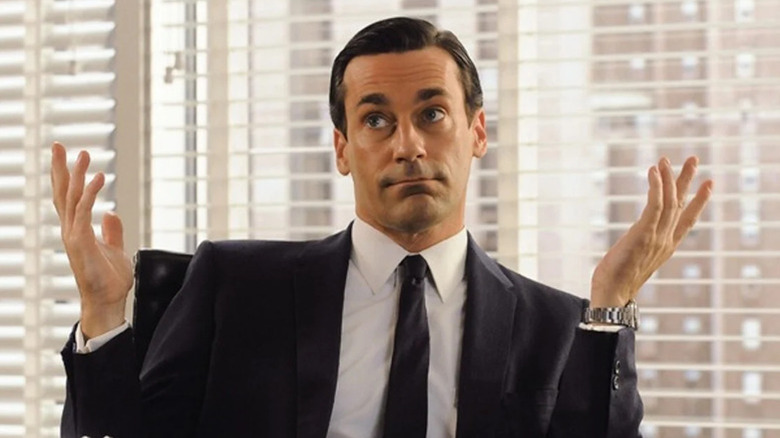 Don shrugging at his desk on Mad Men