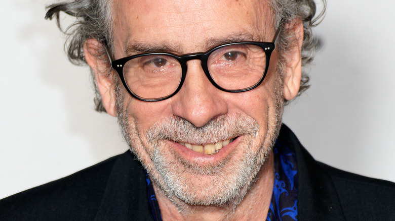 Tim Burton in glasses smiling