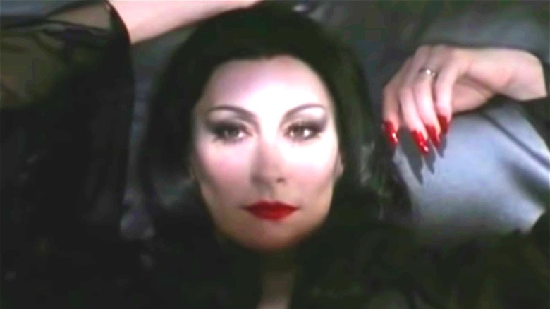 Anjelica Huston Morticia Addams lying down