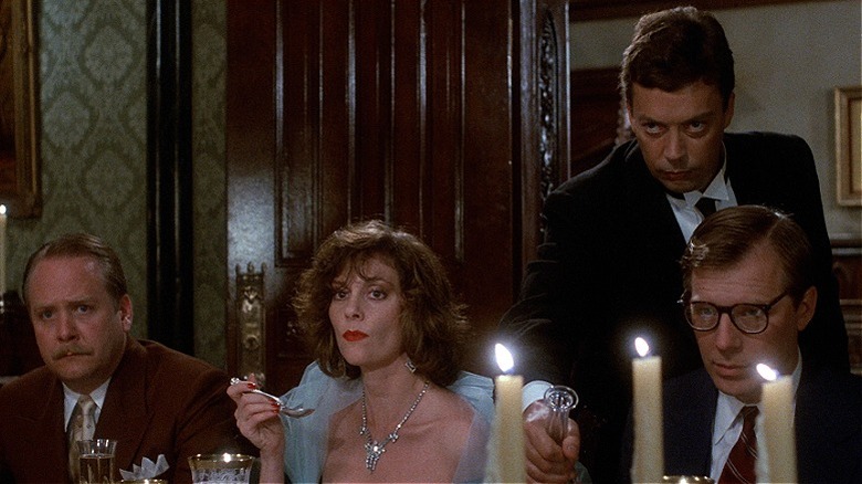 Wadsworth pouring wine for the guests while looking mysterious in Clue