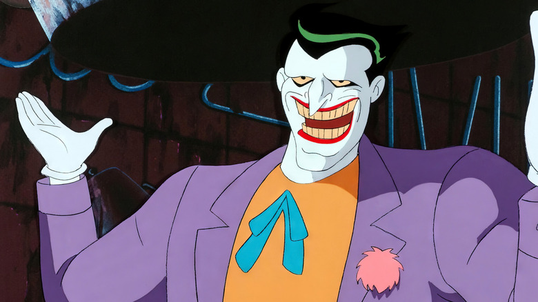 The Joker smiles with his arms raised in "Batman: The Animated Series"