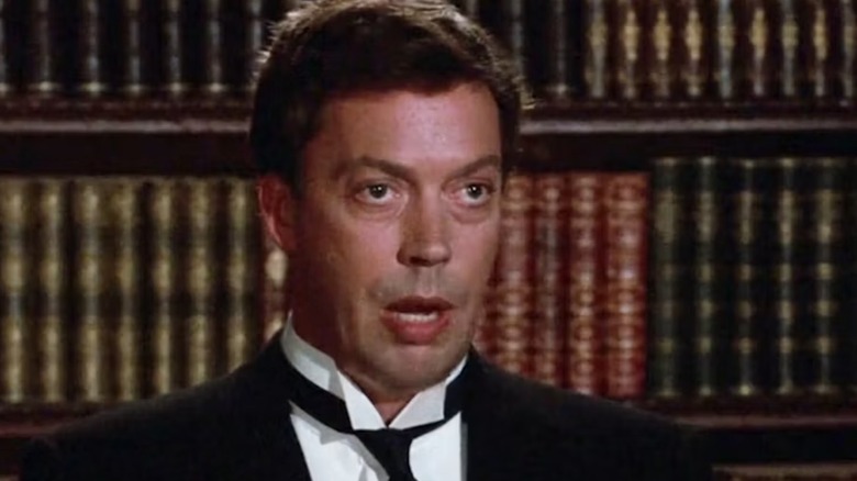 Wadsworth with his mouth open in front of books in Clue