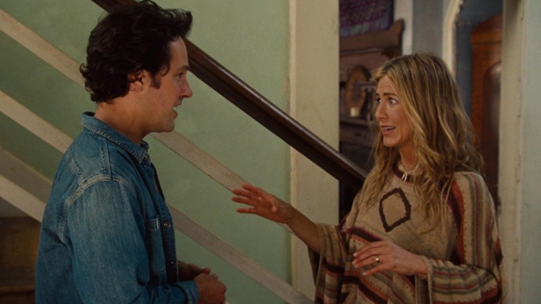 George and Linda Gergenblatt talking next to a staircase in Wanderlust