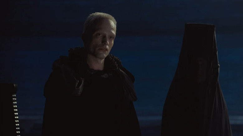 Paul Atreides looing thoughtful and standing by the fire in Dune: Part Three