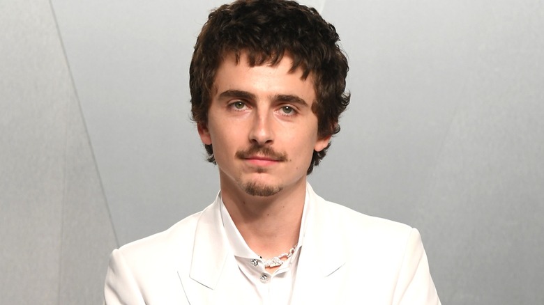 Timoth&eacute;e Chalamet looking serious at the 2026 Vanity Fair Oscar Party