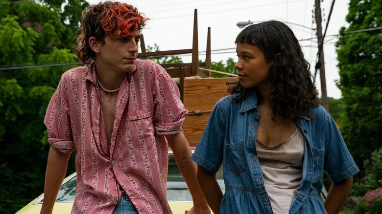 Lee and Maren sitting on a car in 