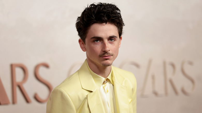 Timothée Chalamet posing for a photo at the Oscars 2025