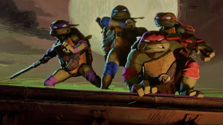 Turtles striking a hero pose atop building