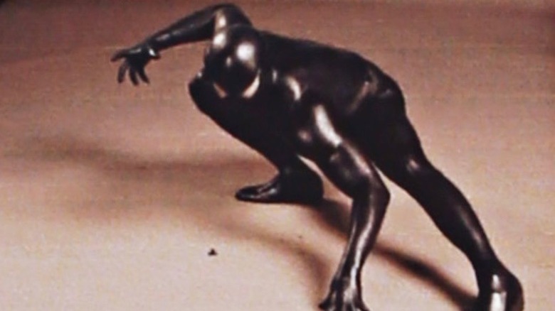 Actor posing in early symbiote Spider-Man suit