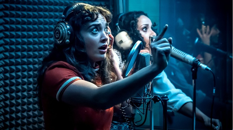 Two girls in a recording booth in 