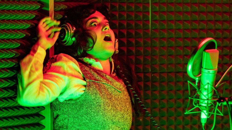 A performer feigns terror in the recording booth in 