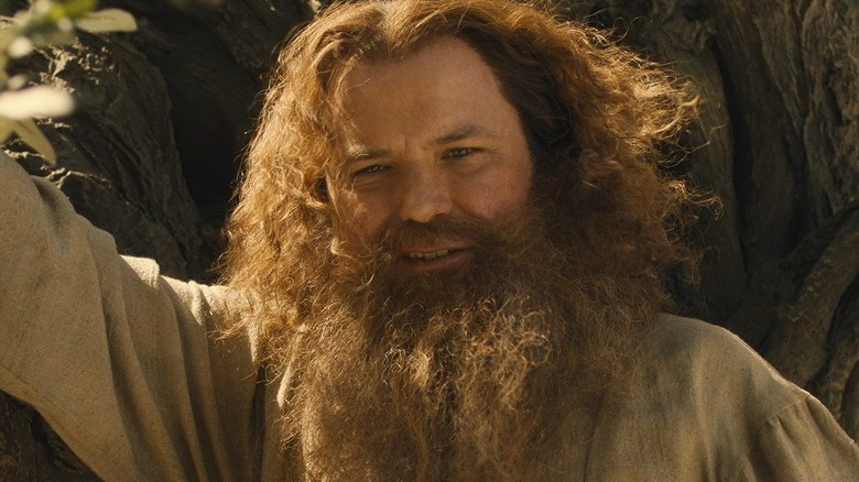 Tom Bombadil leans on a tree in 