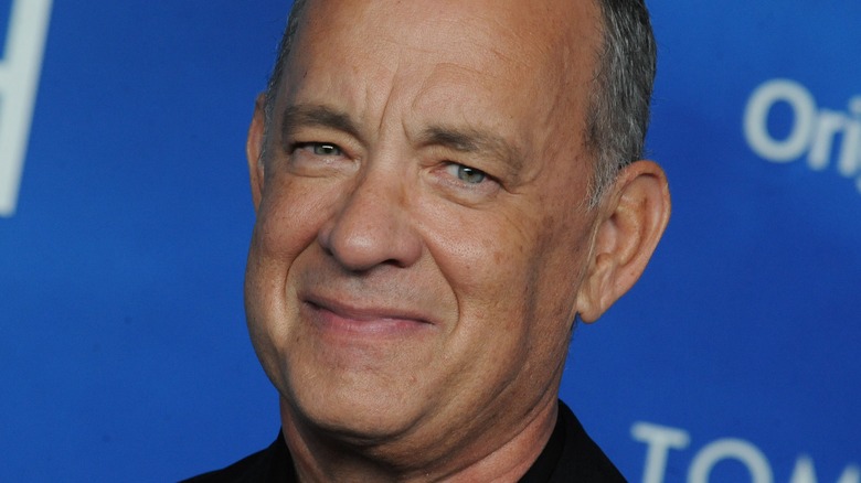 Tom Hanks smirks