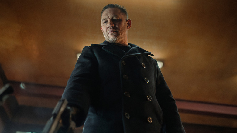 Harry Da Souza points a gun down at a victim in "Mobland" (2025-present)