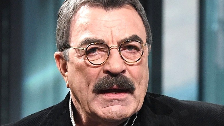 Tom Selleck wearing circular frame glasses