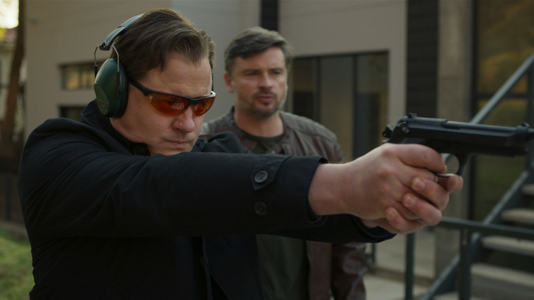 Peter shooting as Vincent watches in Professionals
