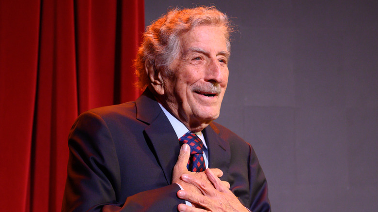 Tony Bennett holding his chest
