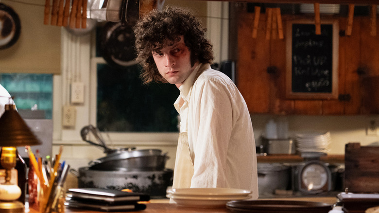 Tony in the kitchen scowling with a black eye in Tony