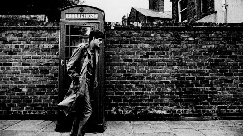 Ian Curtis walking past a telephone box in "Control"