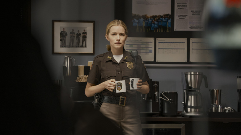 Roscoe Conklin holds coffee mugs on "Reacher" (2022-present)