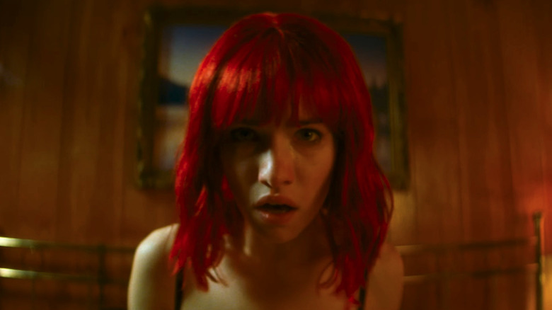 The Lady sitting upright in bed in "Strange Darling" (2024)
