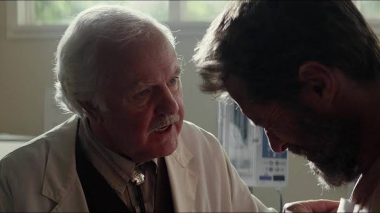 An old doctor talks with Logan Howlett in Logan