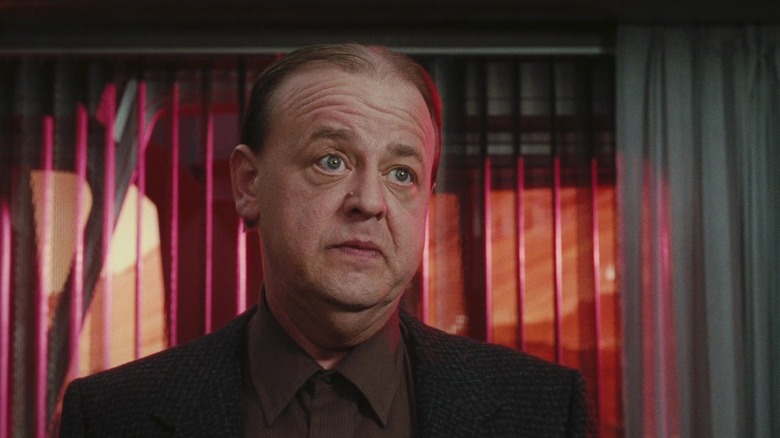 Roy Brocksmith with a gun to his head