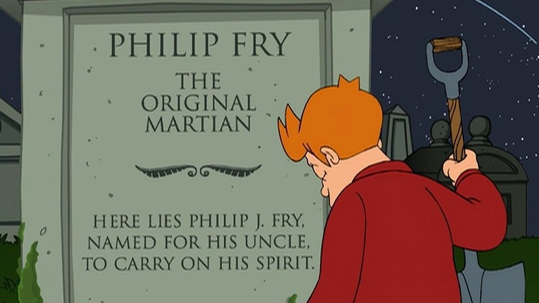 Fry, holding a shovel, sits before his nephew's gravestone in "Futurama" (1999-present)