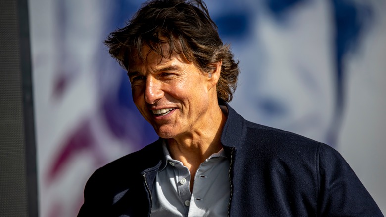 Tom Cruise wearing a navy blue jacket