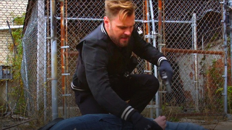 Patrick Flueger planting gun on perp