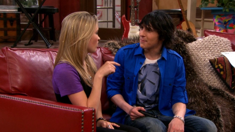 Oliver sitting on a couch with Lilly on 