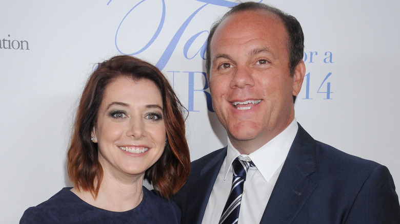 Alyson Hannigan and Tom Papa posing at an event in 2014