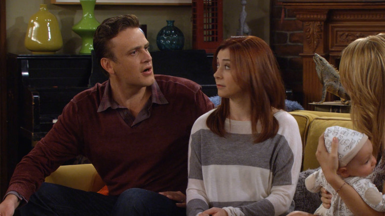 Marshall sitting on a couch with Lily on "How I Met Your Mother" (2005-2014)