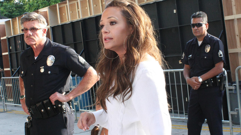 Remini on the street with police officers