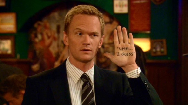 Barney Stinson showing "um... I guess" written on his hand in How I Met Your Mother (2005)