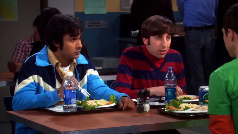 Raj Koothrappali and Howard Wolowitz sitting at a table in The Big Bang Theory