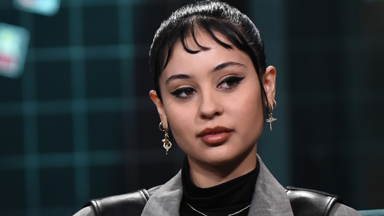 Alexa Demie with bangs and dangly earrings