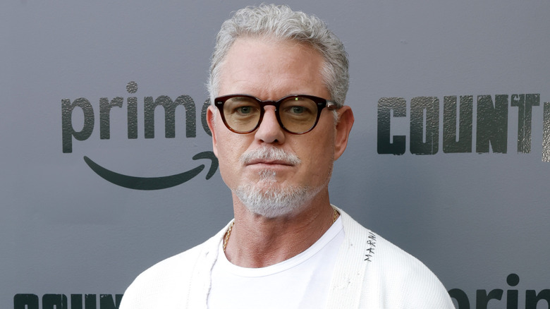 Eric Dane in sunglasses and a white sweater