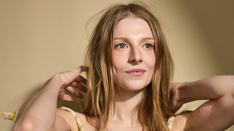 Hunter Schafer fixing her hair