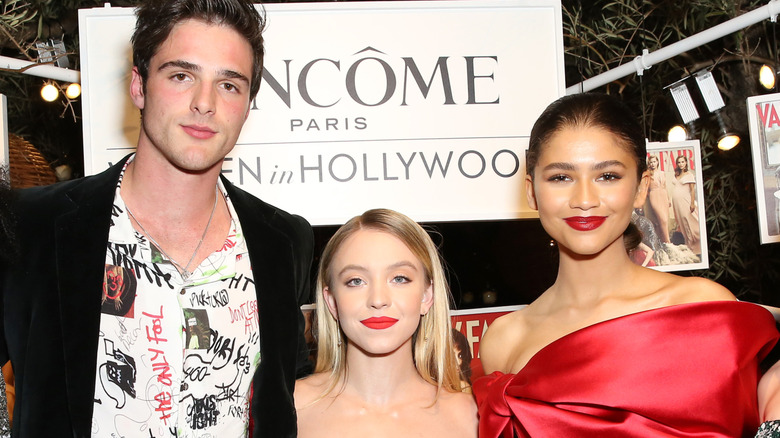 Jacob Elordi, Sydney Sweeney, and Zendaya in front of a Lancome sign