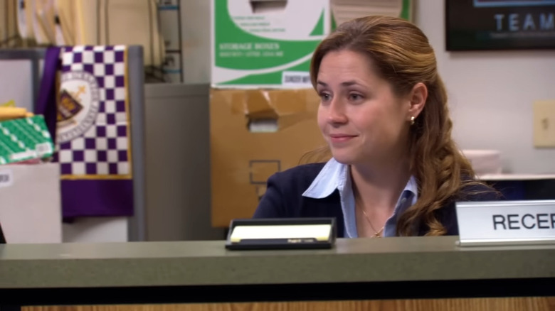 Pam Beesly sitting at her desk on "The Office" (2005-2013)